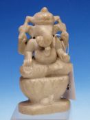 AN INDIAN WHITE MARBLE CARVING OF GANESH SEATED ON A LOTUS THRONE WITH HIS VAHANA MOUSE AT ITS BASE.