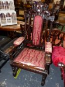 A STUART STYLE OAK ELBOW CHAIR CRESTED BY LIONS SUPPORTING A SHIELD ABOVE THE UPHOLSTERED BACK PAD