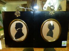TWO OVAL SILHOUETTES, ONE OF A YOUNG MAN AND THE OTHER OF A CHILD CALLED MARY WITH GILT DETAILING.
