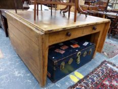 AN UNUSUAL COUNTRY MADE ANTIQUE AND LATER PINE PLANK TOP TABLE WITH FLAPS TO THE NARROW SIDES RISING