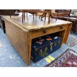 AN UNUSUAL COUNTRY MADE ANTIQUE AND LATER PINE PLANK TOP TABLE WITH FLAPS TO THE NARROW SIDES RISING