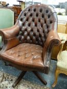 A BUTTONED LEATHER HOOP BACK DESK CHAIR ROTATING ON CRUCIFORM LEGS