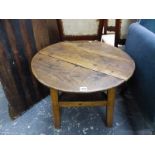 AN OAK CRICKET TABLE, THE THREE PLANK TOP ON LEGS JOINED BY A GALLERIED TRIANGULAR STRETCHER. Dia.