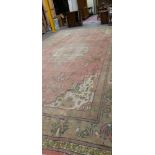 AN OLD COUNTRY HOUSE CARPET PROBABLY INDIAN. 665 x 408cms