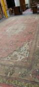 AN OLD COUNTRY HOUSE CARPET PROBABLY INDIAN. 665 x 408cms