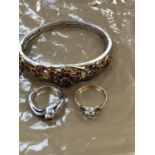 A VINTAGE DECORATIVE GILT PINK STONE SET BANGLE, AND TWO RINGS, ONE 9ct GOLD THE OTHER SILVER.