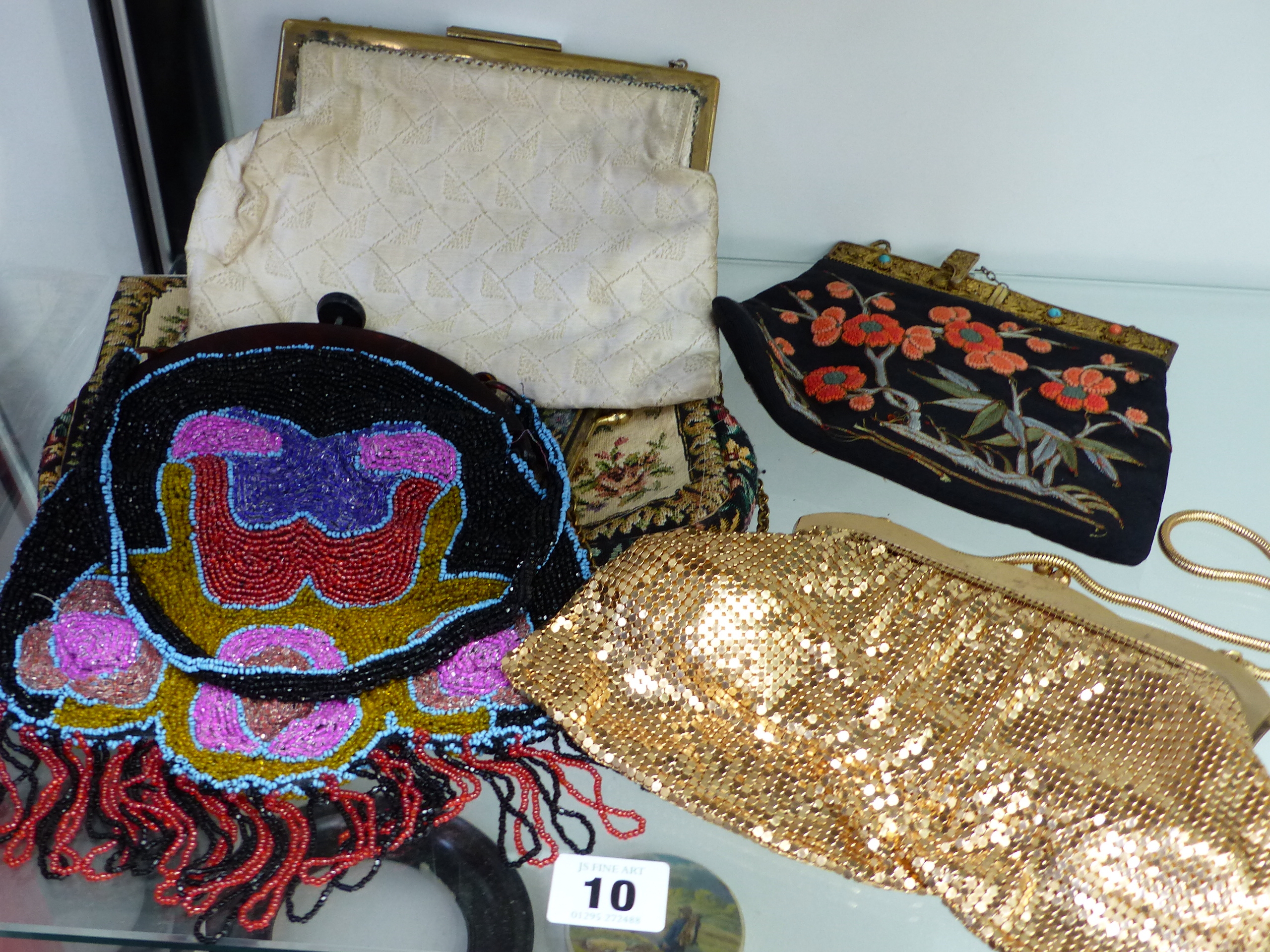 AN INTERESTING VINTAGE BEADWORK EVENING BAG, AN EMBROIDERED EXAMPLE AND THREE OTHERS.