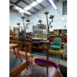 A PAIR OF NEOGOTHIC BRASS THREE LIGHT CANDELABRA ON CYLINDRICAL OAK COLUMNS AND OCTAGONAL FEET. H
