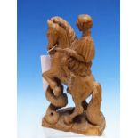 AN OLIVE WOOD CARVING OF A GREEK SOLDIER AND HIS HORSE REARING AS IT IS BITTEN BY A SNAKE. H 20.