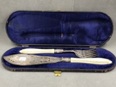 A PAIR OF VICTORIAN SILVER HALLMARKED SILVER CASED FISH SLICE AND FORK SERVERS, WITH IVORY