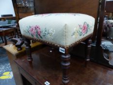 A MAHOGANY STOOL WITH FLORAL NEEDLE WORK SEAT ABOVE BALUSTER TURNED LEGS