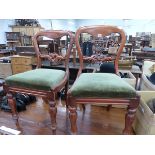 A SET OF FOUR VICTORIAN BALLOON BACKED CHAIRS, THE OLIVE GREEN VELVET SEATS ON OCTAGONAL BALUSTER