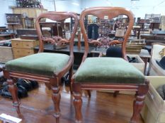 A SET OF FOUR VICTORIAN BALLOON BACKED CHAIRS, THE OLIVE GREEN VELVET SEATS ON OCTAGONAL BALUSTER