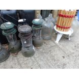 FIVE VINTAGE TILLY LAMPS, TOGETHER WITH A SMALL FRUIT PRESS, SIX LARGE GLASS BOTTLES.