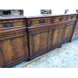 A MAHOGANY BREAKFRONT SIDE CABINET WITH FOUR DRAWERS OVER FOUR DOORS AND BRACKET FEET. W 196 x D
