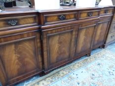 A MAHOGANY BREAKFRONT SIDE CABINET WITH FOUR DRAWERS OVER FOUR DOORS AND BRACKET FEET. W 196 x D