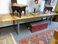 A PINE EXTENDING DINING TABLE, THE SEVEN PLANK TOP WITH CLEATED ENDS AND ON PAINTED TAPERING SQUARE