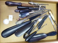 SIXTEEN BUTTON HOOKS WITH EBONY AND OTHER HANDLES, AN EBONY SHOEHORN, THREE SHOE HORN BUTTON HOOK