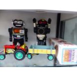 TWO VINTAGE BATTERY OPERATED ROBOT TOYS, AND A TIN PLATE TRACTOR AND TRAILER.