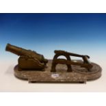 A BRONZE SUNDIAL NOON DAY CANNON- MAGNIFYING GLASS ON ADJUSTABLE ARMS ON MOTTLED PINKISH GREY AND