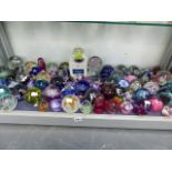 AN EXTENSIVE COLLECTION OF GLASS PAPERWEIGHTS