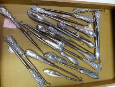 TWENTY THREE STEEL BUTTON HOOKS LARGELY WITH HALLMARKED SILVER HANDLES