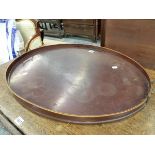 AN ANTIQUE BRASS HANDLED MAHOGANY OVAL TRAY, THE GALLERY RIM WITH LINE INLAY. 77 x 55cms.