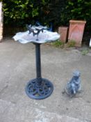 A CAST IRON BASED BIRD BATH AND A SMALL LEAD GARDEN FIGURE.