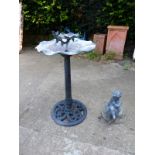 A CAST IRON BASED BIRD BATH AND A SMALL LEAD GARDEN FIGURE.