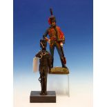 A BRONZE FIGURE OF A MILITARY TRUMPETER STANDING ON A BLACK STONE BASE. H 28cms. TOGETHER WITH AN