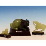 A CHINESE GREEN AND BLACK BOWENITE CARVING OF A RABBIT. W 13cms. TOGETHER WITH TWO GREEN STONE