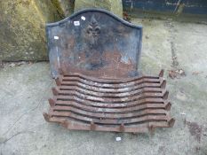 A CAST IRON FIRE BACK AND GRATE.