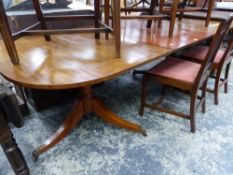 A MAHOGANY D-END DINING TABLE WITH SINGLE LEAF SUPPORTED ON TWO GUN BARREL COLUMNS AND TRIPODS