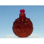 A CHINESE RUBY GLASS SNUFF BOTTLE WITH EUROPEAN STOPPER, EACH SIDE CARVED WITH A FISH ON ITS BACK