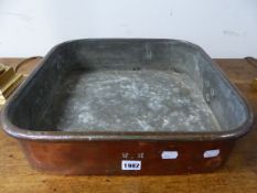 AN ANTIQUE SQUARE TINNED COPPER TWO HANDLED COOKING PAN. 43.5 x 43.5cms.