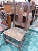 A 17th C. OAK CHAIR, THE WAVY TOP RAIL ABOVE A PLANK SPLAT INLAID WITH A ROUND ARCH TOPPED