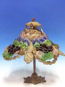 A TABLE LAMP AND A CEILING LIGHT SHADE BOTH MOUNTED WITH ROWS OF INDIVIDUAL COLOURED GLASS FLOWER