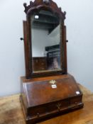 A GEORGIAN MAHOGANY DRESSING TABLE MIRROR, THE CUTWORK CREST CENTRED BY A SHELL, THE SUPPORTING ARMS