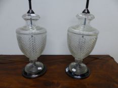 A PAIR OF CUT GLASS BALUSTER URN SHAPED TABLE LAMPS. H 55cms.