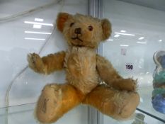 A VINTAGE JOINTED TEDDY BEAR BY DEANS