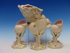 FOUR 19th C. ROYAL WORCESTER GLAZED PARIAN PINK TINTED SHELLS HELD UP ON CORAL AND FURTHER SHELLS,