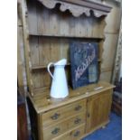 A ANTIQUE PINE DRESSER WITH ENCLOSED TWO SHELF BACK, THE BASE WITH A BANK OF THREE DRAWERS FLANKING