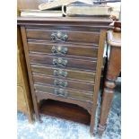 AN EADWARDIAN MAHOGANY MUSIC CABINET WITH SIX DRAWERS ABOVE AN OPEN SHELF