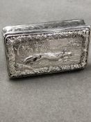 A VICTORIAN SILVER HALLMARKED SNUFF BOX, WITH RAISED RUNNING FOX DECORATION AMONGST A RURAL SCENE