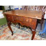 A GEORGE III OAK LOWBOY WITH THREE DRAWERS ABOVE THE WAVY APRON AND CABRIOLE LEGS ON PAD FEET. W
