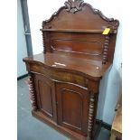 A VICTORIAN SERPENTINE FRONTED MAHOGANY CHIFFONIER SIDE CABINET, THE BACK WITH A FOLIATE CARVED TOP