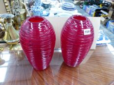 A PAIR OF RED GLASS VASES.