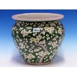 A CHINESE GREEN GROUND PLANTER PAINTED WITH CHERRY BLOSSOM, FOUR CHARACTER MARK IN RED. Dia. 27.5