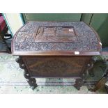 A BURMESE MAHOGANY COFFER, THE LID CARVED WITH A TEMPLE SCENE WITHIN FOLIAGE AND BIRDS, THE SIDES