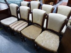 A SET OF EIGHT VICTORIAN MAHOGANY DINING CHAIRS, EACH WITH UPHOLSTERED SCROLL BACKS WITHIN CHANNELL